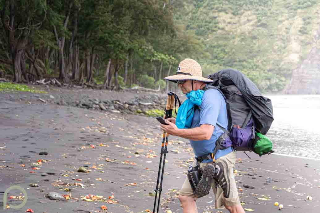 man backpacking on beach