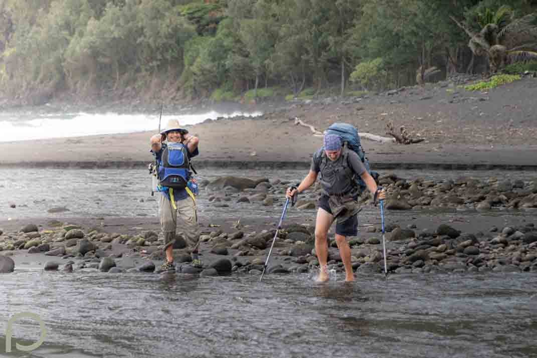 men crossing a river
